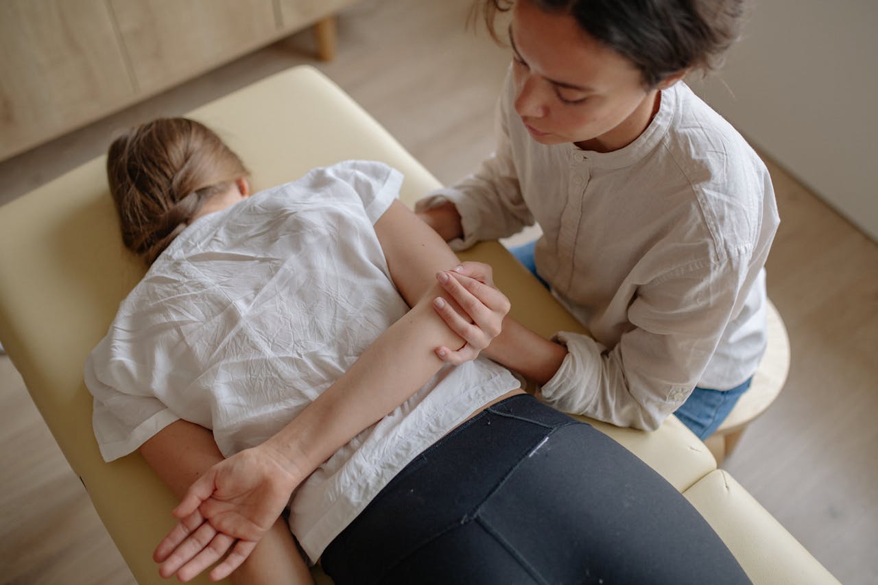 contact-img A woman receiving chiropractic treatment on a massage table for relaxation and health.